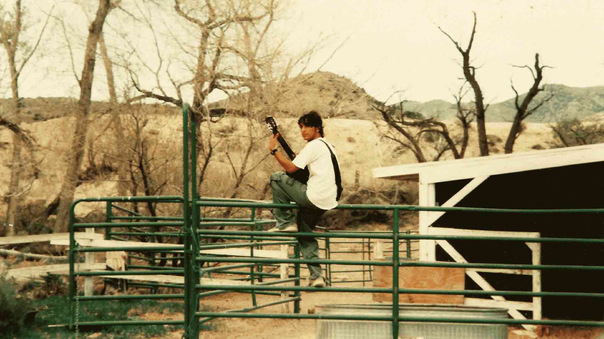 Pieces of an Angel by Raúl Hurtado Raúl playing on a fence in the desert