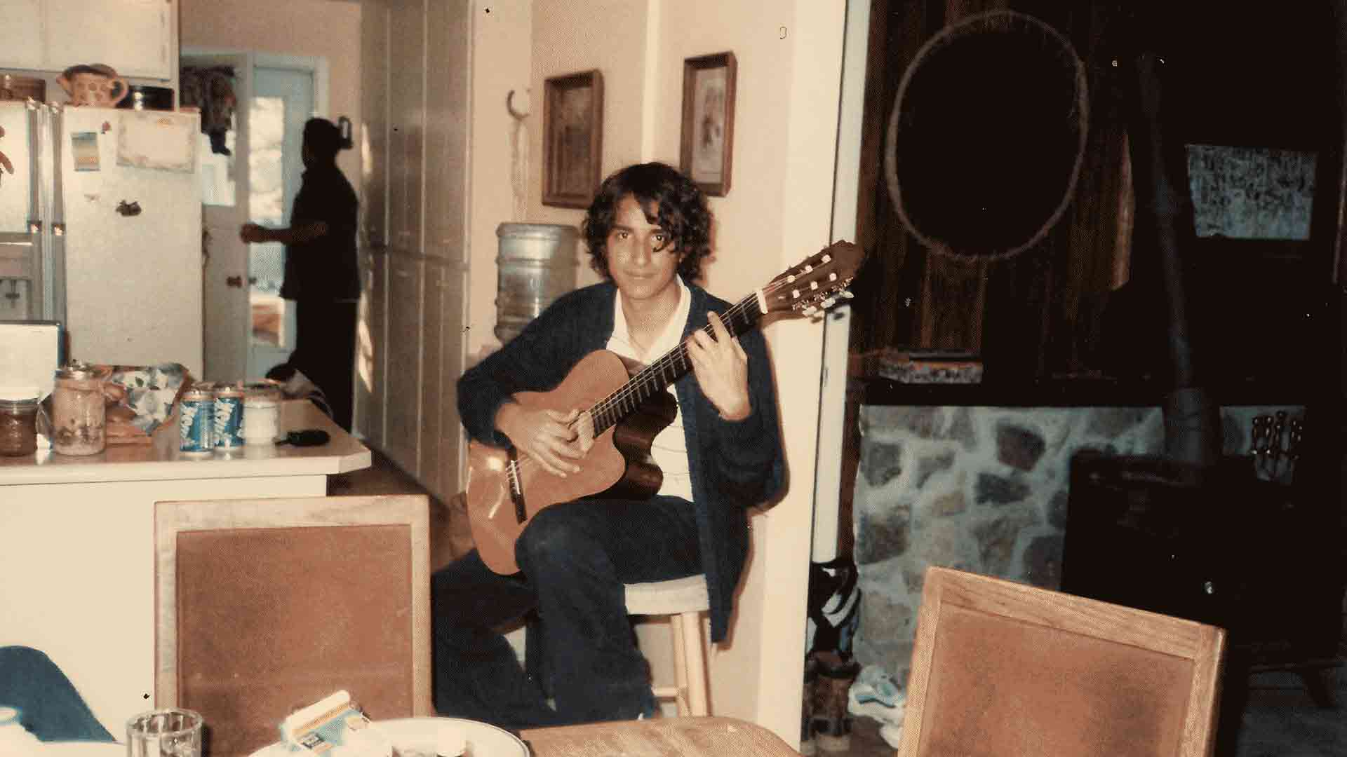 The Silence of the Lost Souls by Raúl Hurtado Raúl sitting in the kitchen and playing the guitar